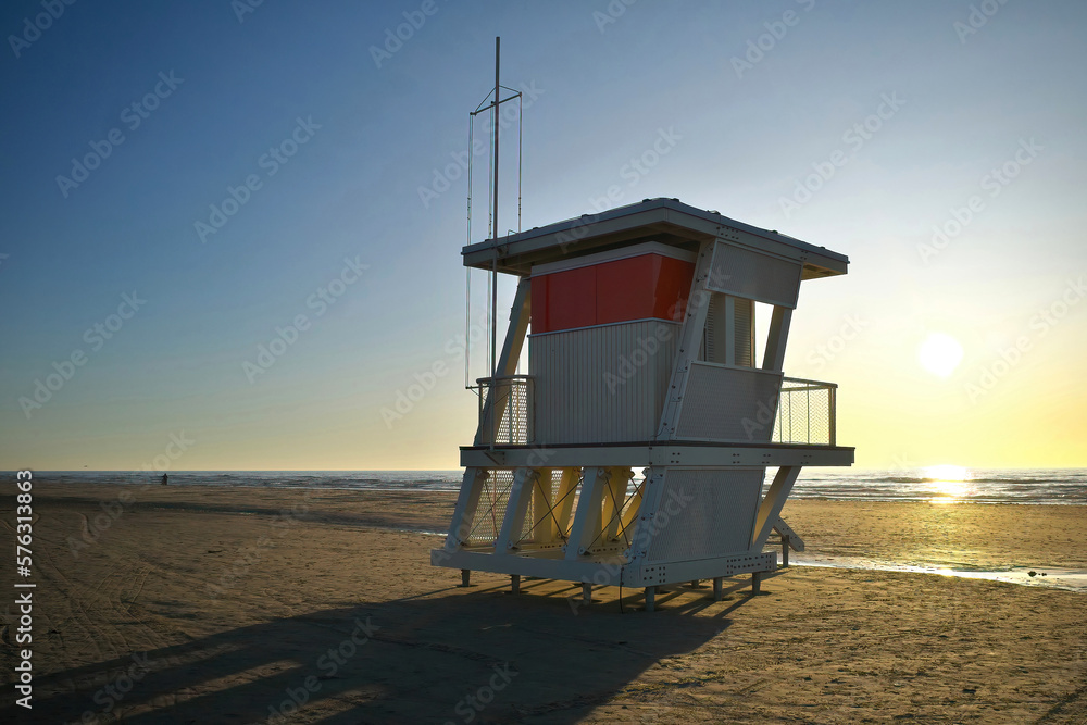 White life tower on the beach at sunset. White life tower on the beach at sunset.