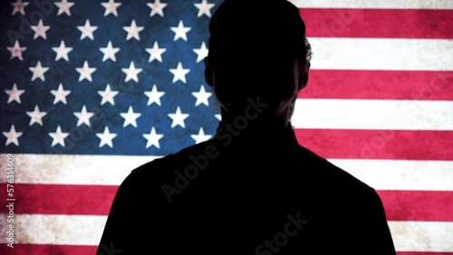 A soldier salutes against the background of the flag. US soldiers. US Army.