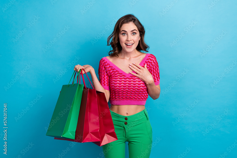 Photo of astonished positive lovely lady wear pink stylish clothes arm showing herself rejoice gifts isolated on blue color background Photo of astonished positive lovely lady wear pink stylish clothes arm showing herself rejoice gifts isolated on blue color background