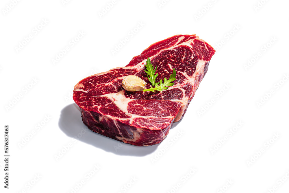 Raw Ribeye steak with spices and herbs isolated on white background. Trendy hard light, dark shadow Raw Ribeye steak with spices and herbs isolated on white background. Trendy hard light, dark shadow