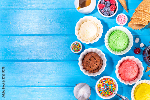 Ice cream festival background, Summer ice cream buffet with various gelato sundaes flavors. sweet toppings and sprinkles, high-colored blue wooden background to view copy space