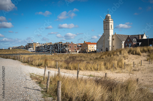Seaside resort Katwijk aan Zee in The Netherlands, view of white church and walkways along sand dunes photo