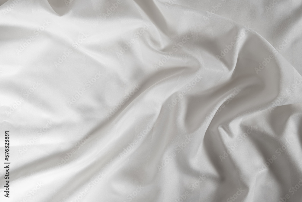 Satin crumpled fabric of white color, top view. Natural bed linen, sheets, abstract background of luxury fabric, wavy folds Satin crumpled fabric of white color, top view. Natural bed linen, sheets, abstract background of luxury fabric, wavy folds