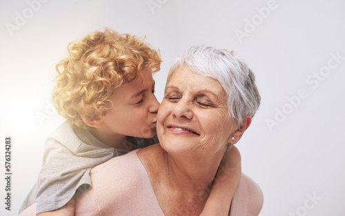 Love you so much, Granny. Shot of a little boy giving his grandmother a kiss on the cheek.