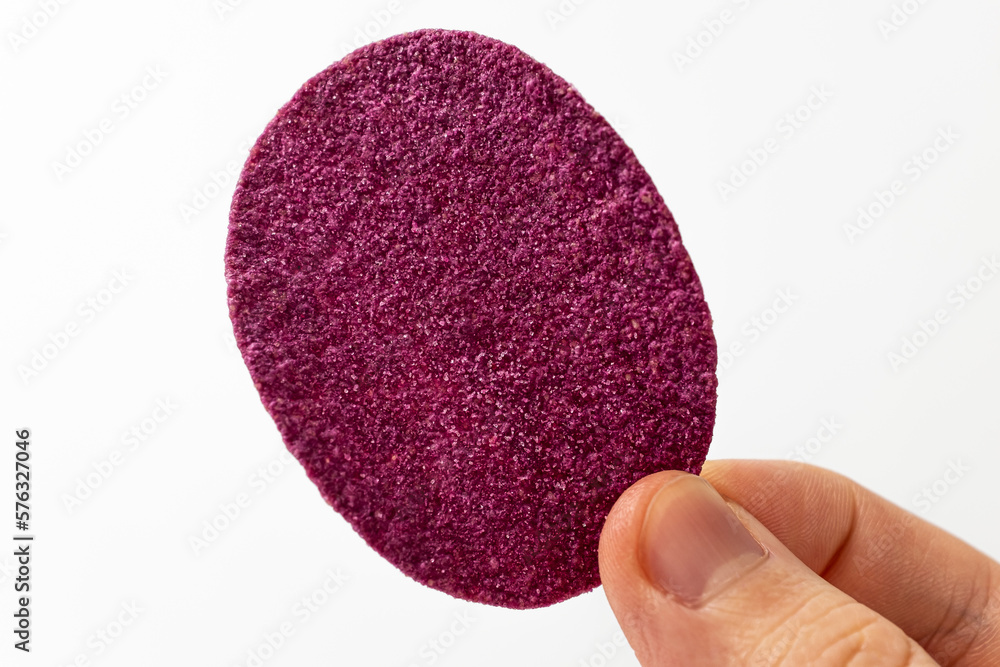 Purple sweet potato chips on a white background Purple sweet potato chips on a white background