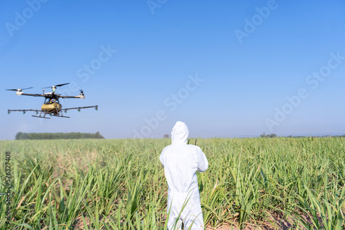 Farmer fly drone spray insecticide using high technology increasing productivity agriculture y in agriculture