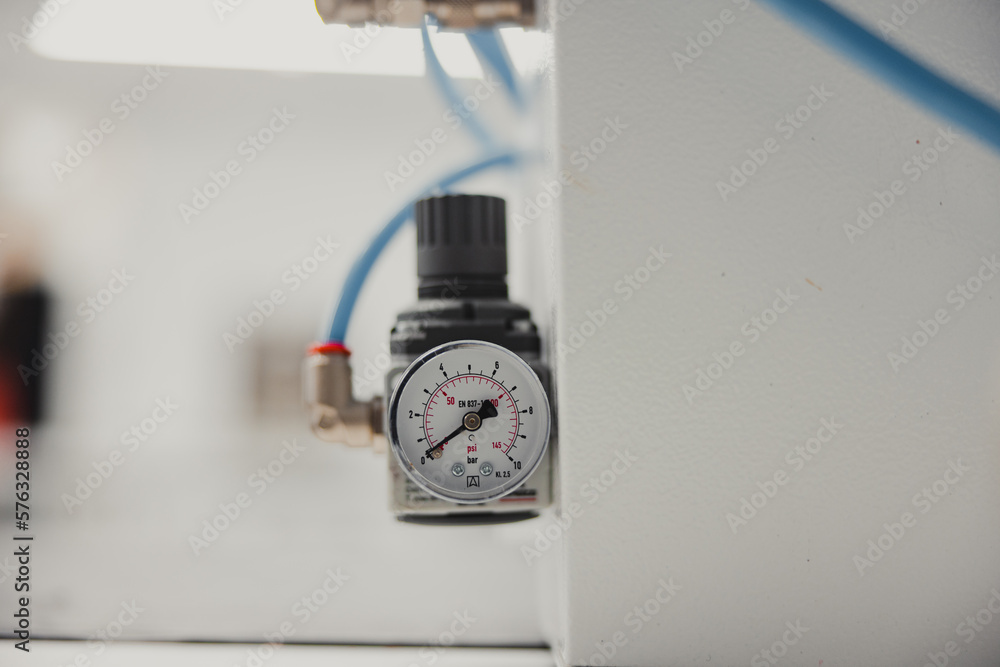Close-up of a pressure gauge on a white wall in a factory Close-up of a pressure gauge on a white wall in a factory