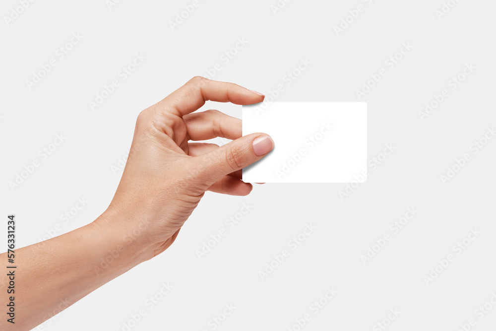 Woman's hand showing credit card, or card, or business card or voucher, isolated on white background, template, mock-up Woman's hand showing credit card, or card, or business card or voucher, isolated on white background, template, mock-up
