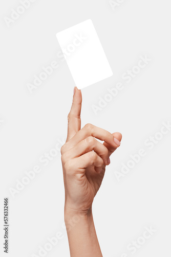 Woman hand showing, or holds with fingertip, or juggling with card or business card or voucher, isolated on white background