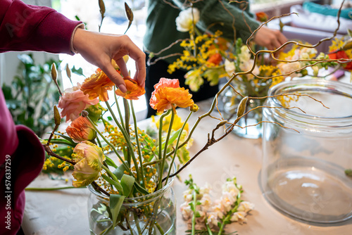 Women hands make bouquet at flower workshop