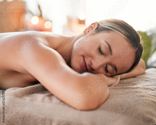 Relax, spa and sleeping woman in massage bed for wellness, peace and luxury zen. Face, female and resort rest for body care, therapy and pamper treatment, happy and smile with stress free relaxation