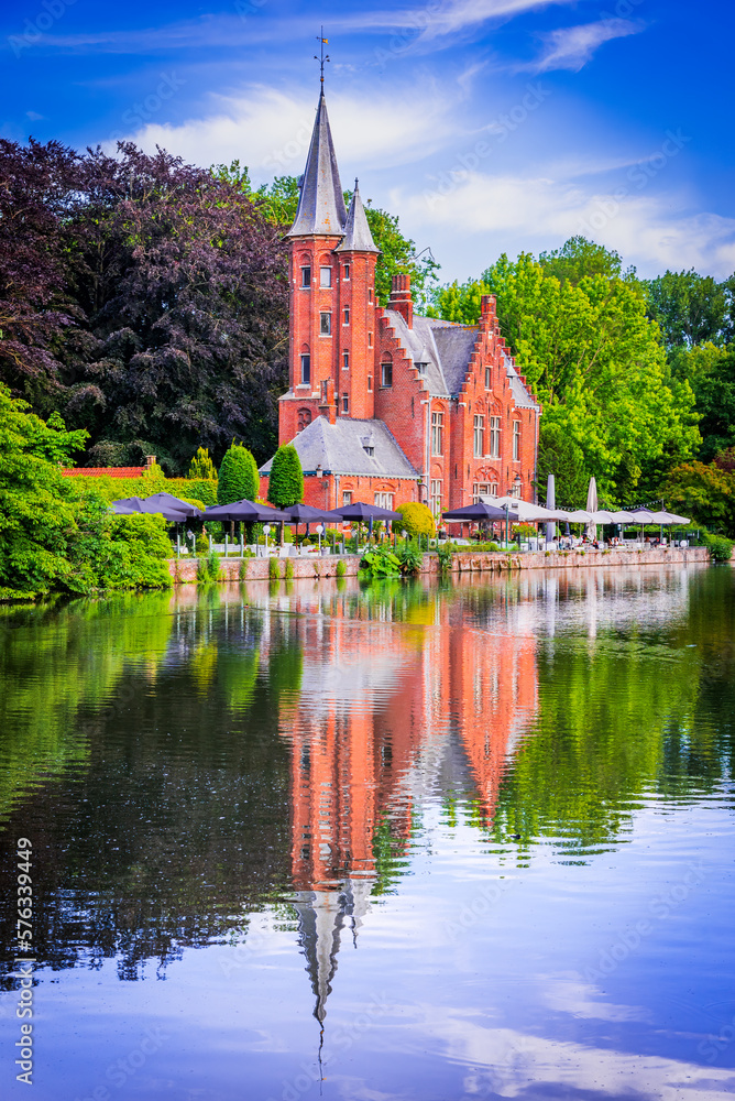 Bruges, Belgium. Minnewater, tranquil lake with lush greenery in romantic
