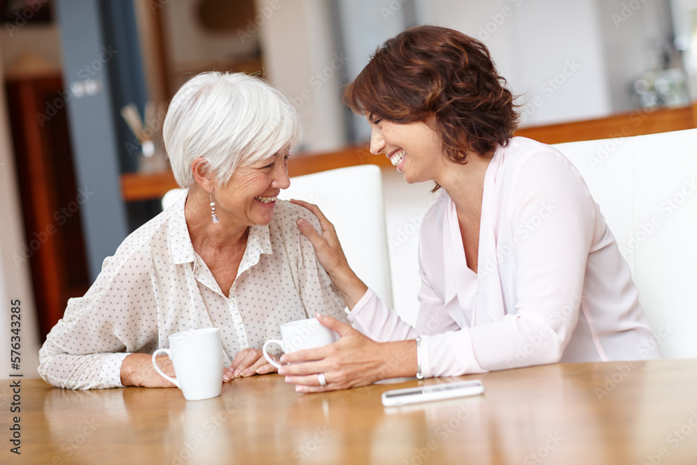 Having a good time over coffee. Shot of a senior woman and her daughter chatting over coffee. Having a good time over coffee. Shot of a senior woman and her daughter chatting over coffee.
