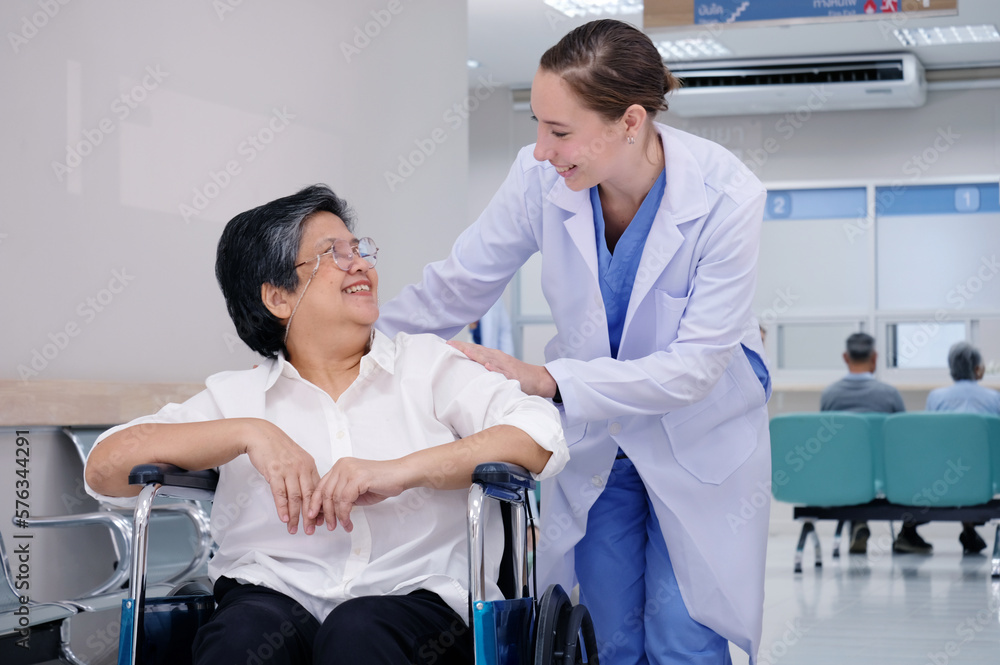 Female doctor with old female patient sitting in a wheelchair Female doctor with old female patient sitting in a wheelchair