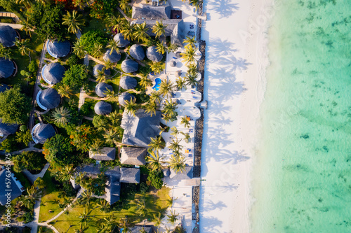 This stunning toned aerial view captures the beauty of Kiwengwa beach in Zanzibar, Tanzania. The luxurious resort and the turquoise ocean water create a picture-perfect scene.