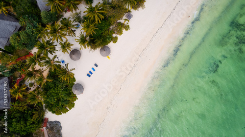 The stunning beauty of Kiwengwa beach in Zanzibar is on full display in this mesmerizing aerial drone footage  showcasing its palm tree-lined shore and turquoise waters