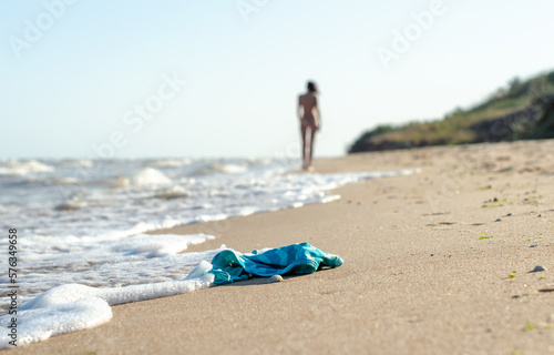 swimsuit in the sand on the beach and naked female figure