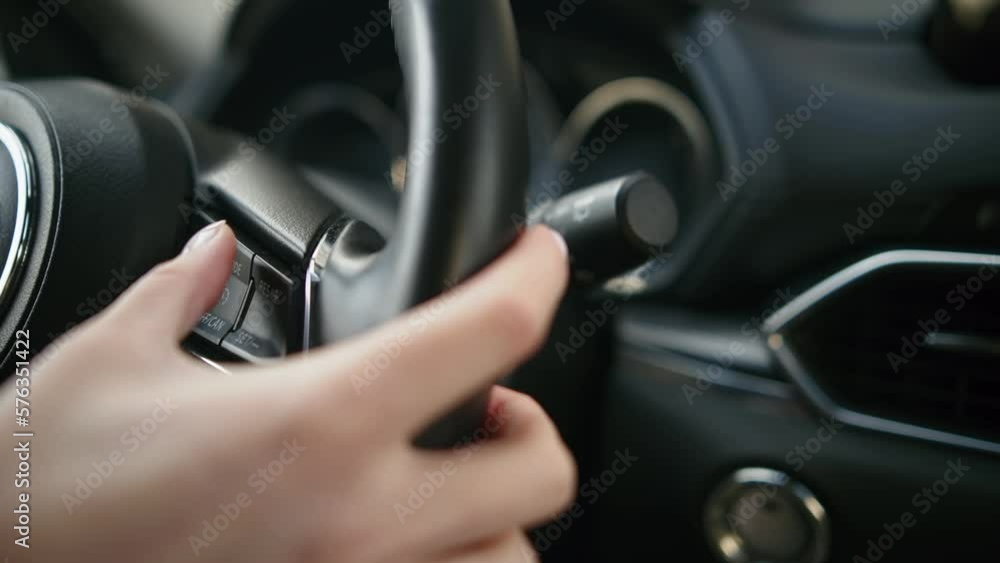 The woman is driving, with hands on the car steering wheel The woman is driving, with hands on the car steering wheel