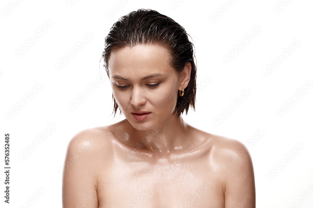 A breathtaking close-up of a woman's sensuous features, accentuated by her hydrated, luminous skin and wet, sleek locks