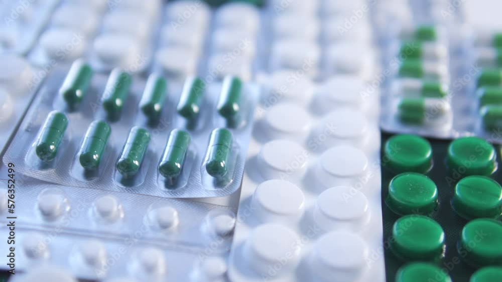 Many white and green pills and tablets lying on table, big choice of hormonal drugs for women, normalization of hormonal levels before pregnancy planning, progesterone, estradiol, prolactin Many white and green pills and tablets lying on table, big choice of hormonal drugs for women, normalization of hormonal levels before pregnancy planning, progesterone, estradiol, prolactin