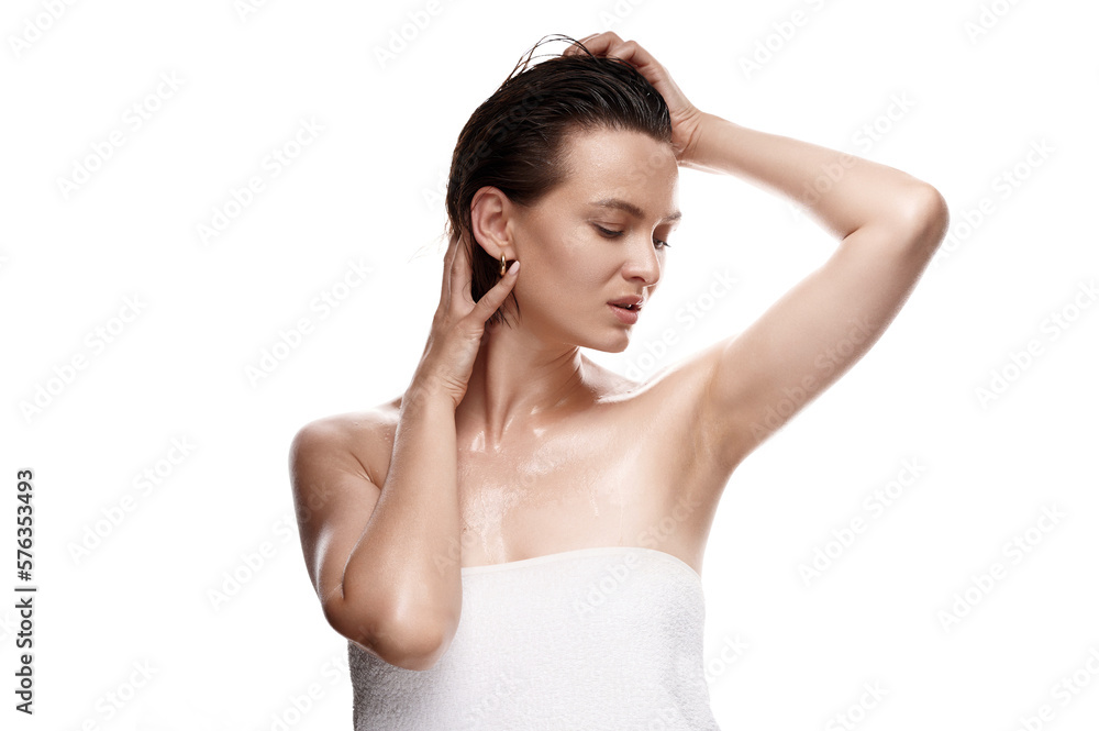 Captivating woman with flawless, moisturized skin and damp hair, enveloped in a towel on a clean, white setting. A stunning image of natural beauty and skincare Captivating woman with flawless, moisturized skin and damp hair, enveloped in a towel on a clean, white setting. A stunning image of natural beauty and skincare