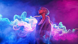 Neon close up portrait of young woman In suit and sunglasses. Psychic Wave - Cyber around smoke concept.