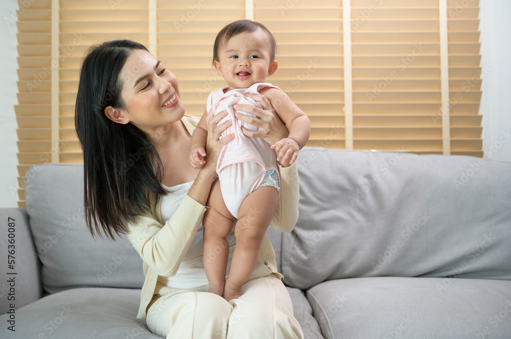 Portrait of mother and baby girl at home, family, child, childhood and parenthood concept Portrait of mother and baby girl at home, family, child, childhood and parenthood concept