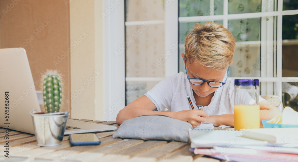 Student doing homework. Boy writing, drawing sitting at the table. School, youth, education concept. Student doing homework. Boy writing, drawing sitting at the table. School, youth, education concept.