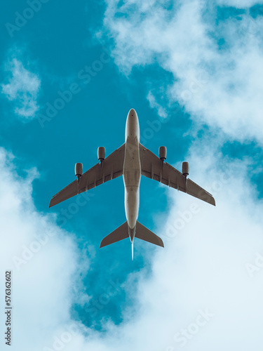 Aeroplane in flight beneath a blue sky with clouds, low flying plane, airbus aircraft