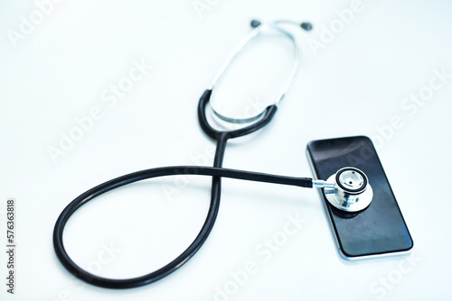 Technology has a heartbeat too. Shot of a stethoscope lying on top of a mobile phone against a white background.