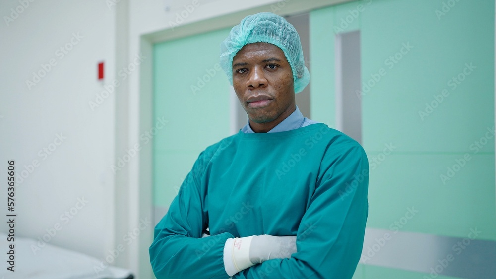 Portrait of African American man professional surgeon in arms crossed position looking confidence into camera. after successful surgical operation in the hospital