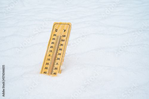 Thermometer in the snow. Winter, wave of frost, snowfall.