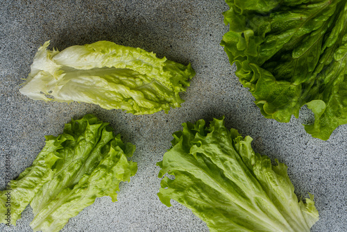 Overhead view of fresh romaine lettuce leaves on a table photo
