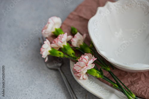 Close-up of a place setting with pink carnation flowers photo