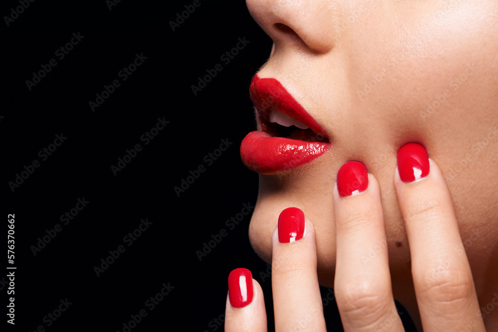 Naklejka premium A splash of COLOR. A cropped studio shot of a beautiful model wearing red lipstick and nailpolish.