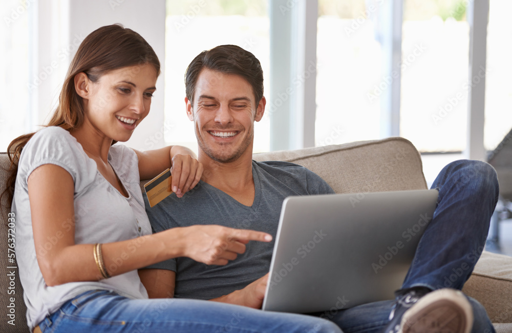 We should totally get that. An affectionate young couple doing some online shopping at home. We should totally get that. An affectionate young couple doing some online shopping at home.