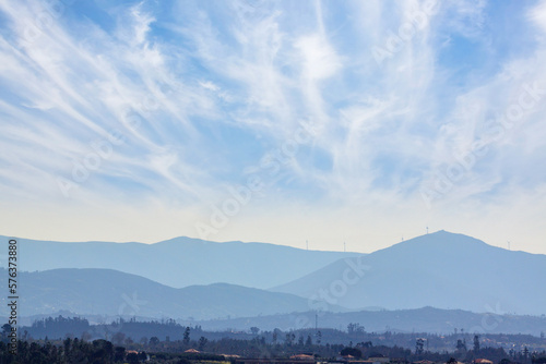 distant mountain view with clouded sky and layered skyline © mikefoto58