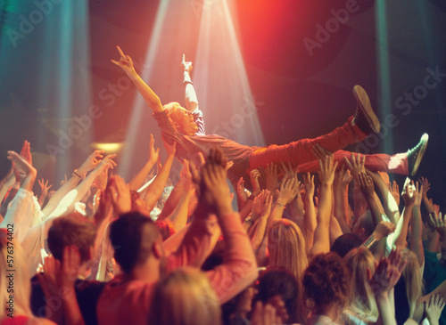 A young man crowd surfing to his favorite band. This concert was created for the sole purpose of this photo shoot, featuring 300 models and 3 live bands. All people in this shoot are model released.