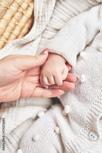 Сhild's palm in parents hands. Happy Mother's and Father's Day. Childhood and parenthood © Aleksandr
