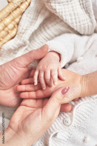 Сhild's palm in parents hands. Happy Mother's and Father's Day. Childhood and parenthood