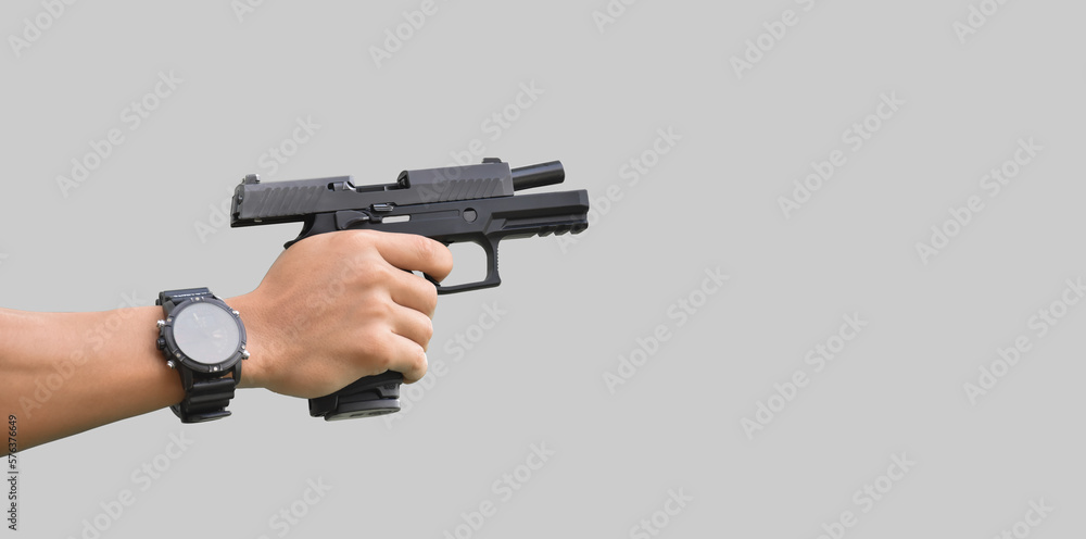 Isolated 9mm pistol gun holding in right hand of gun shooter with clipping paths. Isolated 9mm pistol gun holding in right hand of gun shooter with clipping paths.