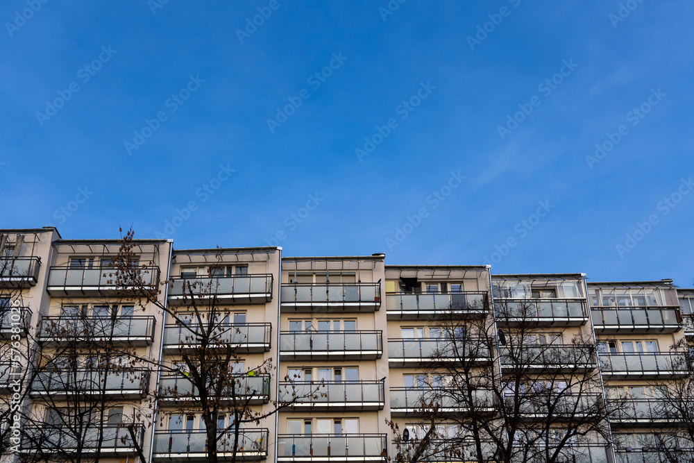 Facade with balconies in an apartment block. Multi-family housing, the object against the blue sky. Facade with balconies in an apartment block. Multi-family housing, the object against the blue sky.