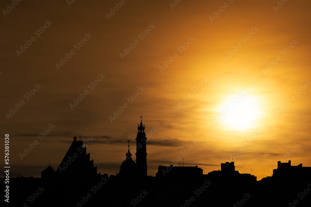 Panoramic view for the Warsaw Old town under the setting sun.. Contours of buildings against the sky with turned up colors