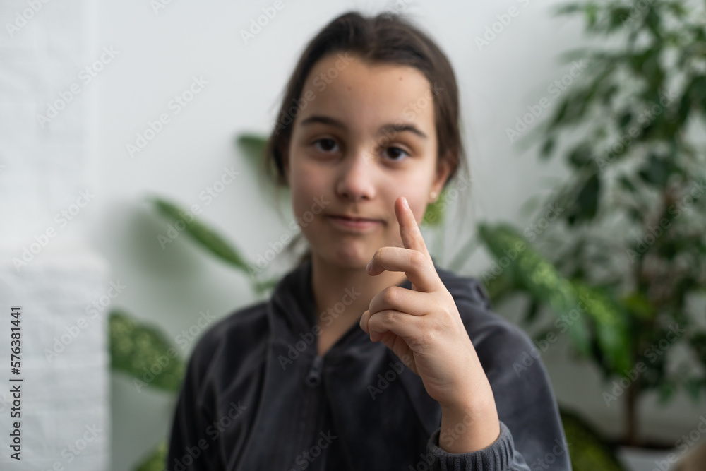 A smiley teenage girl hand sign A smiley teenage girl hand sign