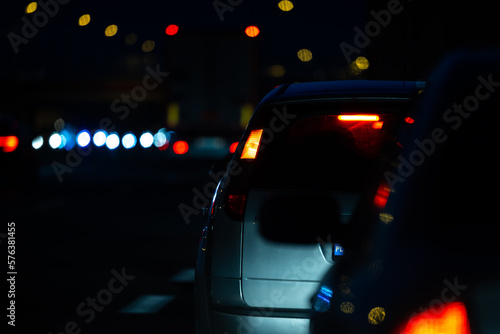 Cars in night traffic jams at highway exit. View of the vehicles from the driver's perspective