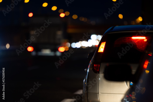 Cars in night traffic jams at highway exit. View of the vehicles from the driver's perspective