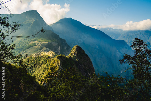 Aerial  above Machu Picchu Valley, Inca Trail, Terraces, Temple, Peru with Andean Cordillera Shining in the Background, UNESCO Protected Site photo