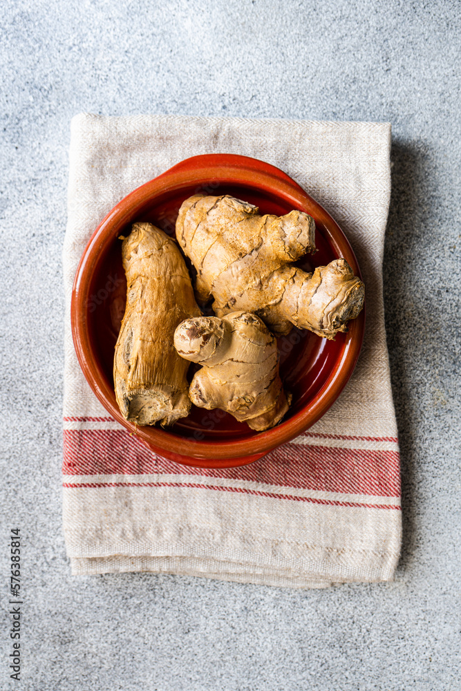 Red ceramic bowl with ginger root