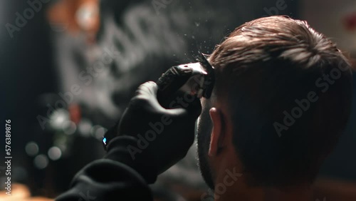 Barbershop male barber hands shaving customer hairs electric trimmer machine closeup slow motion