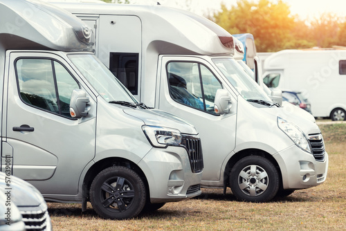 Row of many parked horse box cargo trailer transport and horse transportation rv camper van farm ranch campground horse racing competition. Horsebox carriage lorry animal livestock tranport haulage